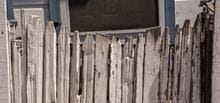 Old white picket fence with peeling paint